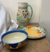 A Charlotte Rhead pottery jug together with a Clarice Cliff plate and a bowl