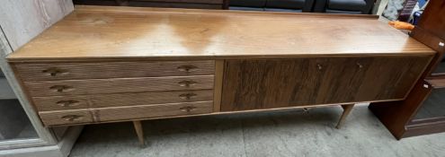 A Mid 20th Century teak sideboard, with four drawers and two cupboards on tapering legs,