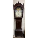 A 19th century mahogany longcase clock with a domed hood and rope twist columns above a short trunk