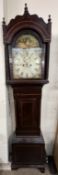 A 19th century mahogany longcase clock with a domed hood and rope twist columns above a short trunk