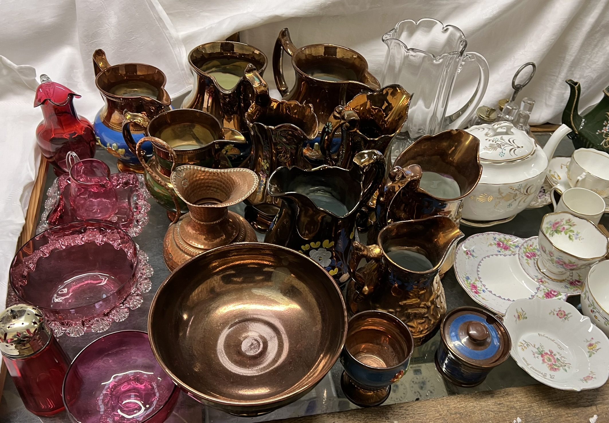 A collection of copper lustre jugs together with other jugs, teapots. - Image 3 of 3