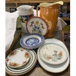 Two pottery water jugs together with assorted plates and bowls