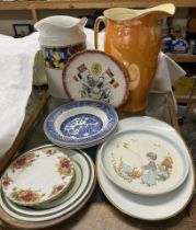 Two pottery water jugs together with assorted plates and bowls