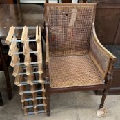 An Edwardian mahogany bergere elbow chair together with two wine racks