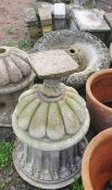 A pair of reconstituted stone urns together with seat pedestals, planters,