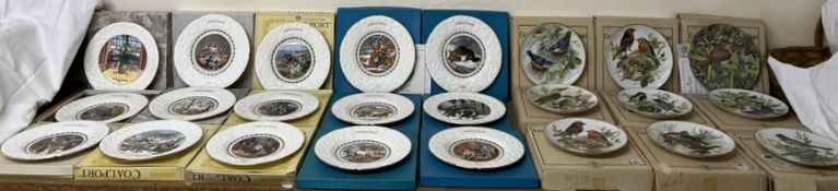 A large collection of Christmas plates together with a set of garden bird plates all boxed