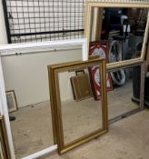 A gilt framed wall mirror together with three other large wall mirrors