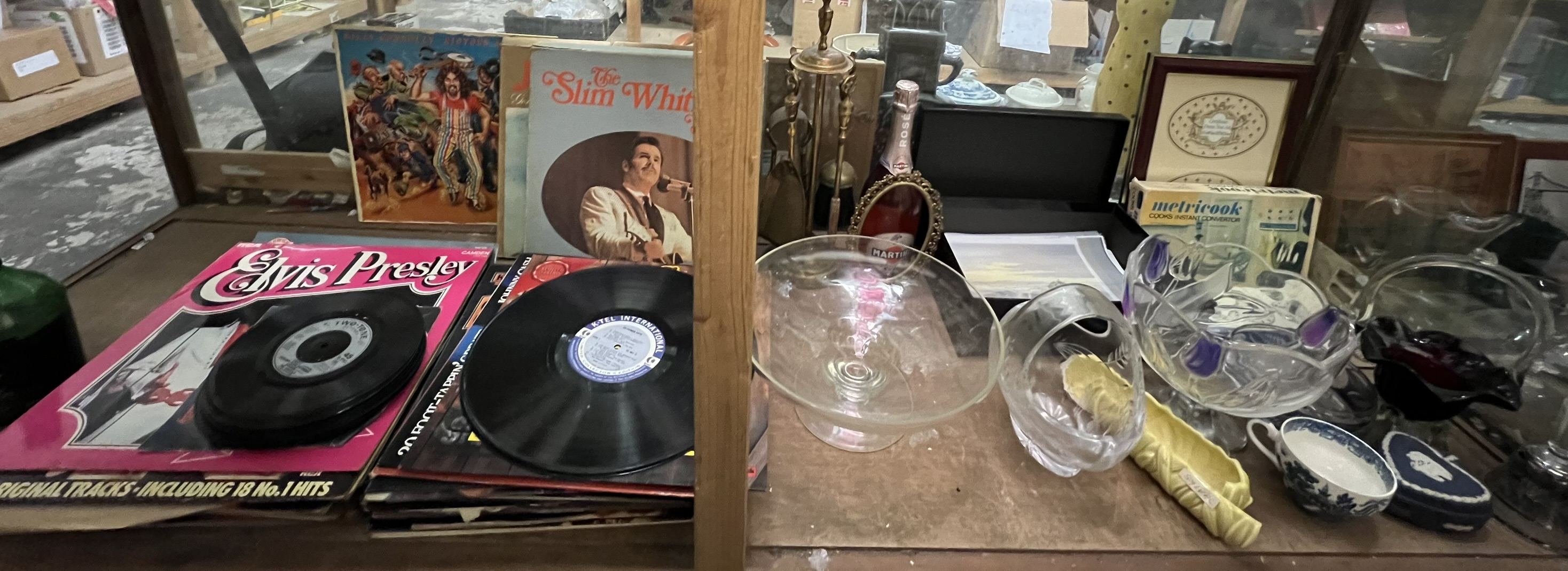 A brass fireside tidy together with glass bowls, records,