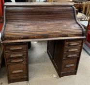 An oak tambour fronted roll top desk,