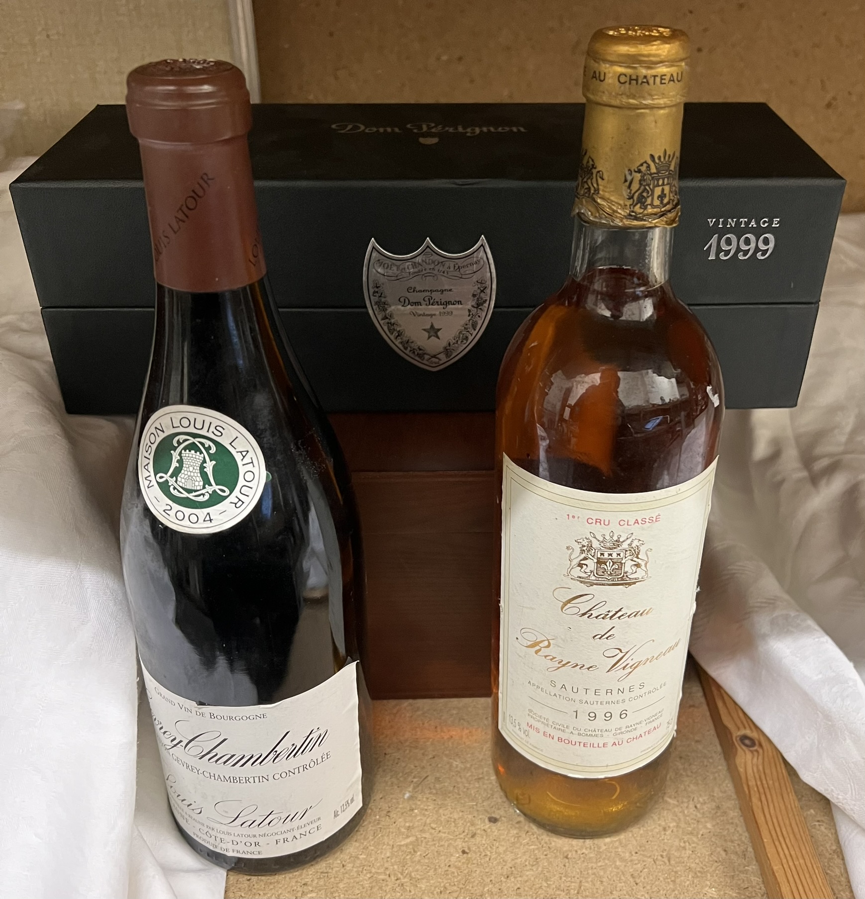 A bottle of 1999 Dom Perignon together with a bottle of Gevrey Chambertin and a 1996 Chateau de