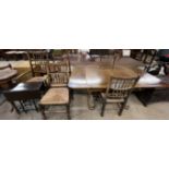 An oak drawleaf dining table together with five spindle back dining chairs and a small drop leaf