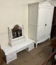 A cream painted armoire together with parts of a dressing table