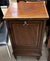 An Edwardian mahogany coal purdonium with a drop front on square tapering legs