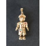 A 9ct yellow gold articulated clown pendant, set with emeralds,