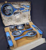 A George V silver, blue enamel and painted dressing table set, comprising two hand brushes,