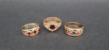 A 9ct gold sapphire and ruby dress ring, size R 1/2 together with two garnet set dress rings,