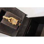 A Lady's gilt metal Gucci wristwatch, with a rectangular dial and gilt metal strap, 6800L,