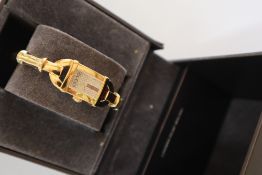 A Lady's gilt metal Gucci wristwatch, with a rectangular dial and gilt metal strap, 6800L,