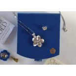 A Clogau 14ct white gold flower pendant set with a central diamond, approximately 3.