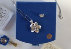 A Clogau 14ct white gold flower pendant set with a central diamond, approximately 3.