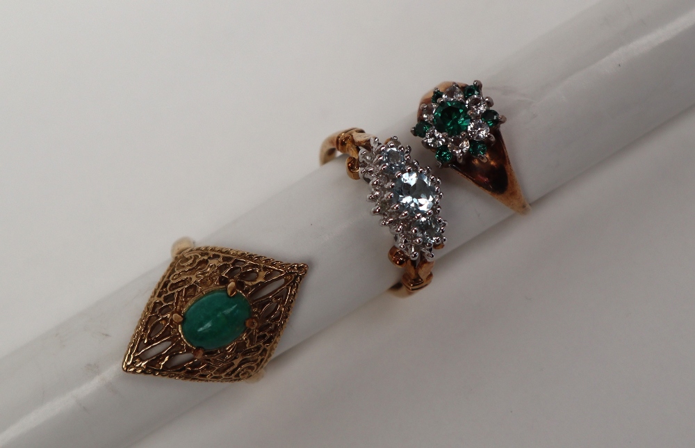 A 9ct gold ring set with a green cabochon stone,