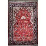 A Quo rug with a pink ground and central mihrab, with cream spandrels and floral guard stripes,