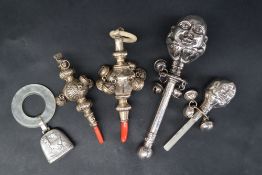 A continental silver babies rattle with head of humpty dumpty with bells and mother of pearl