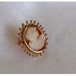 A shell cameo brooch depicting a maiden in profile to a 9ct yellow gold mount,