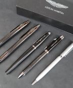 An Aston Martin ballpoint pen and propelling pencil set, boxed together with a Cayenne roller ball,