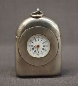 A continental white metal travel clock vesta case, of domed form with a ring top,