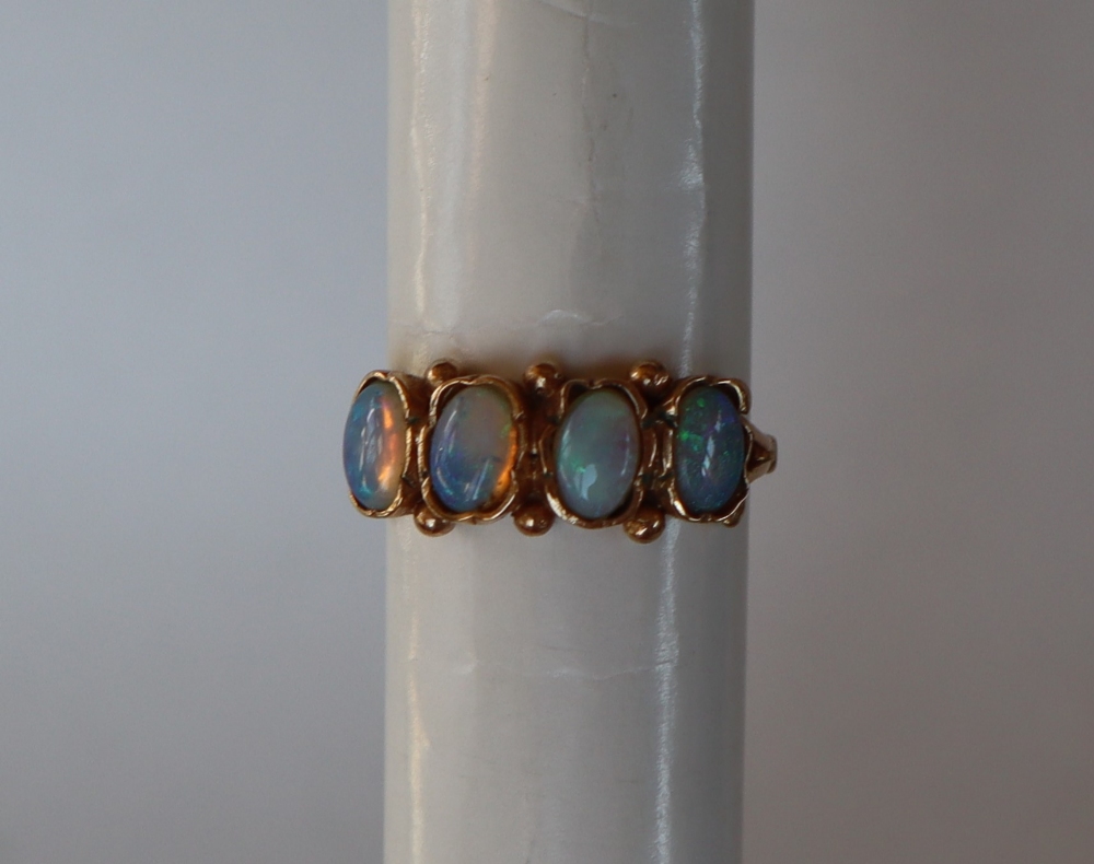 A 9ct gold ring set with four oval moonstones, size M, approximately 2.