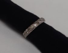 A Diamond half eternity ring set with twelve round old cut diamonds to a white metal setting and