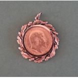 An Edward VII gold sovereign dated 1910 in a 9ct gold acorn and oak leaf slip mount,