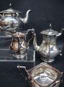 An Edward VII four piece silver tea set, of square form, comprising hot water jug, teapot,