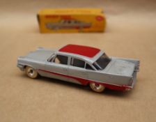 A Dinky Toys 192 De Soto Fireflite Sedan in grey with red roof and flash,