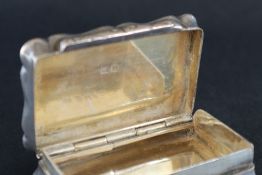 A George V silver snuff box, of shaped rectangular form,