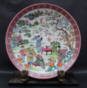 A Chinese Famille Rose porcelain charger decorated with numerous figures in a landscape,