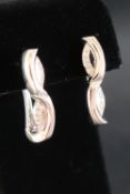 A pair of 18ct white gold earrings set with round diamonds, approximately 8.