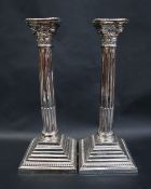 A pair of Elizabeth II silver Corinthian column candlesticks,