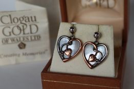 A pair of Clogau yellow and white metal mother of pearl set heart shaped earrings