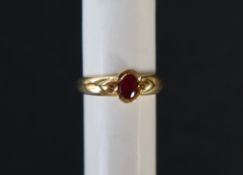 An 18ct yellow gold ring set with an oval faceted ruby, size M 1/2, approximately 2.
