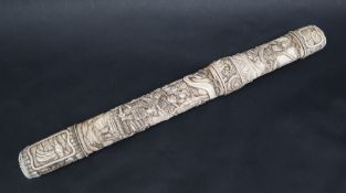 A Japanese carved bone tanto, decorated with figures, dragons, horsemen etc, 36.