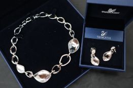 A Swarovski necklace together with a Camrose & Kross faux pearl necklace,