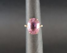 A 9ct yellow gold ring with central oval faceted amethyst, in a raised claw setting, size L 1/2,