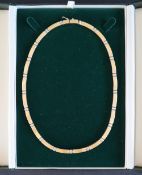An 18ct yellow and white gold necklet set with bars,