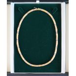 An 18ct yellow and white gold necklet set with bars,