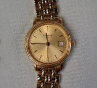 A Lady's gilt stainless steel wristwatch, with a gilt dial and batons,