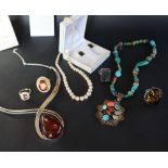 An Amber necklace with a pear shaped drop in a silver mount together with dress rings earrings and