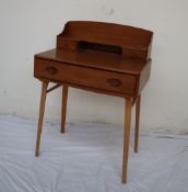 An Ercol writing desk, with a raised superstructure with a shelf, pigeon hole and drawers,