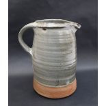 In the style of Hamada Shojii, a stoneware jug with a green glaze 23.